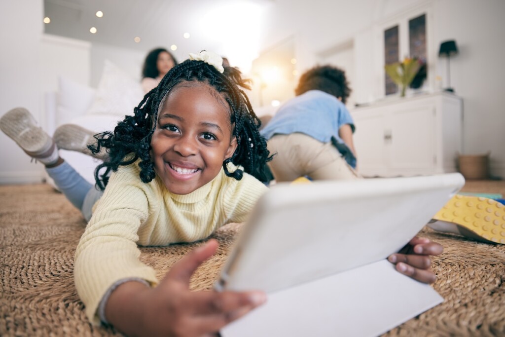 Happy child using her AAC device