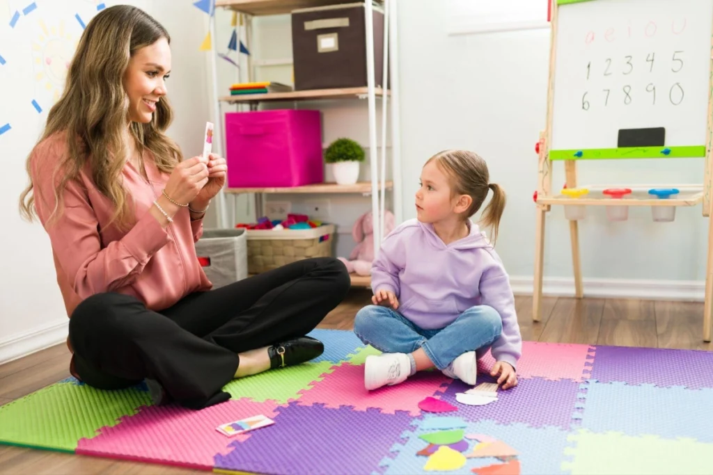 ABA therapist working with a young autistic child during therapy.