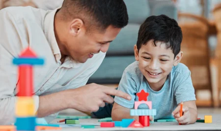 Father and son playing together with blocks